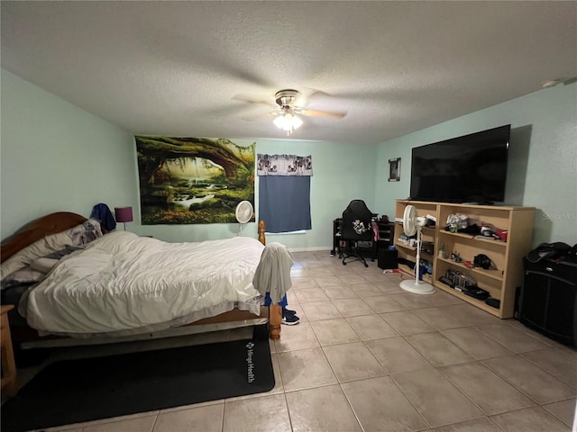 bedroom featuring light tile patterned floors, a textured ceiling, and a ceiling fan