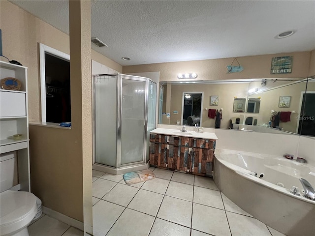 full bathroom with a shower stall, vanity, a whirlpool tub, tile patterned floors, and a textured ceiling