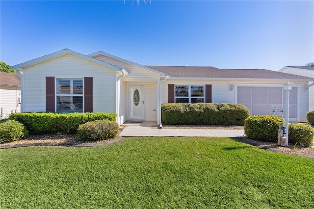 ranch-style home with a front yard and a garage