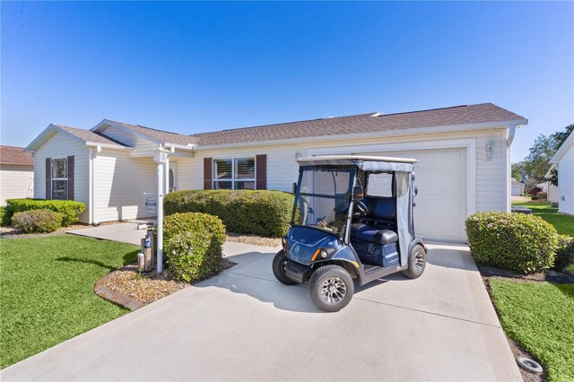ranch-style house featuring concrete driveway and a front lawn