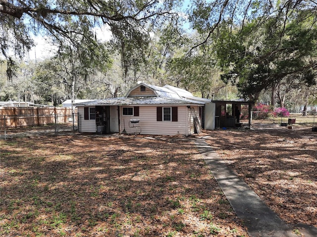 back of property featuring fence