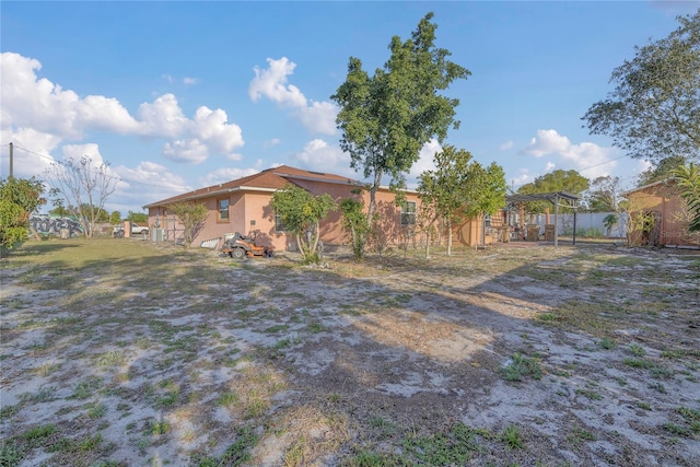 view of yard with a carport and fence