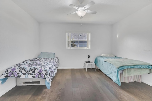 bedroom with baseboards, wood finished floors, and a ceiling fan