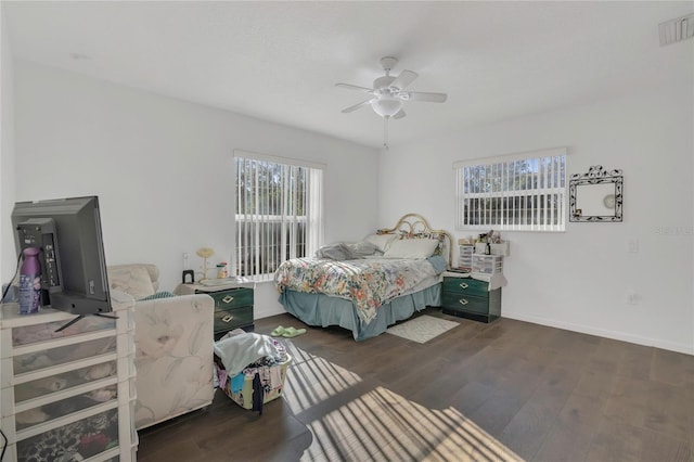 bedroom featuring multiple windows, wood finished floors, and visible vents