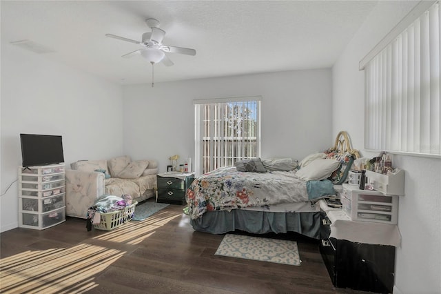 bedroom featuring a textured ceiling, ceiling fan, and wood finished floors