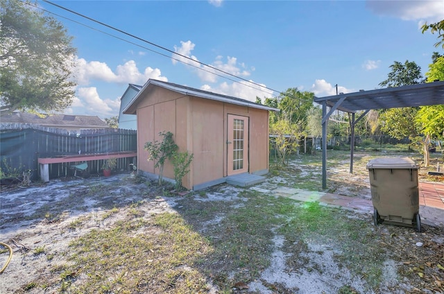 view of shed with a fenced backyard and a pergola