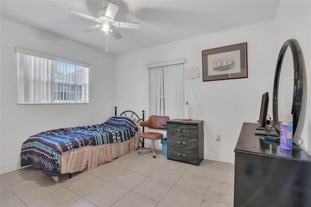 tiled bedroom with a ceiling fan