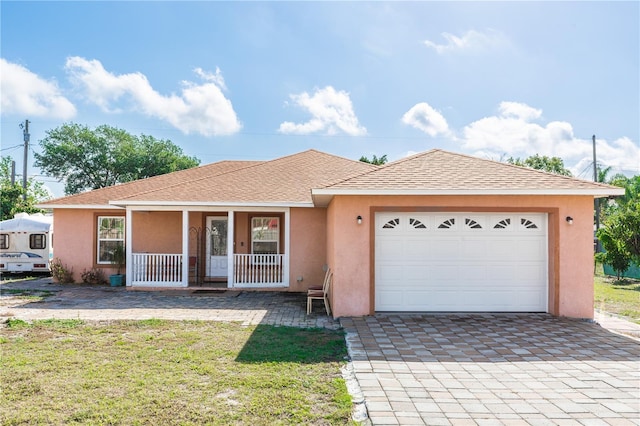 ranch-style home with an attached garage, covered porch, stucco siding, a shingled roof, and decorative driveway