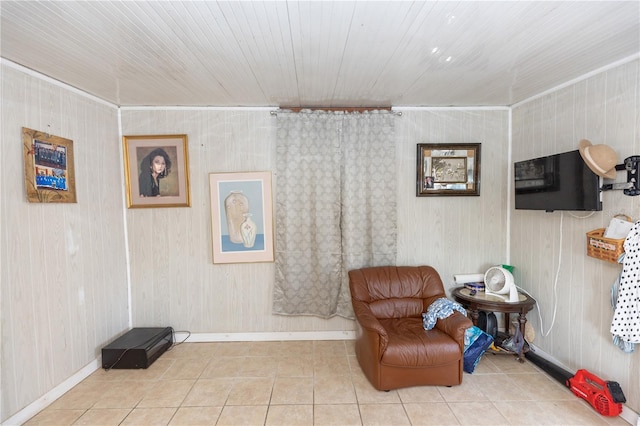 living area with baseboards and tile patterned floors