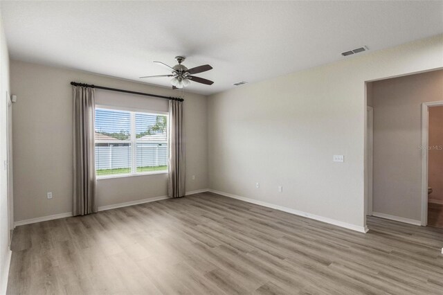 3341 Winchester Estates Cir, Lakeland, FL 33810 - unfurnished room featuring a ceiling fan, light wood-style flooring, and baseboards
