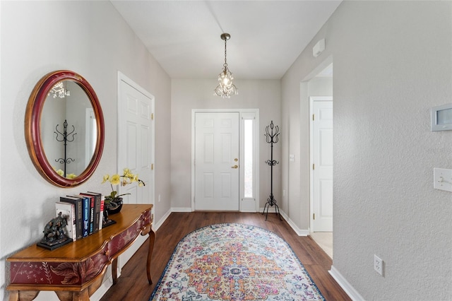 entrance foyer with baseboards and wood finished floors