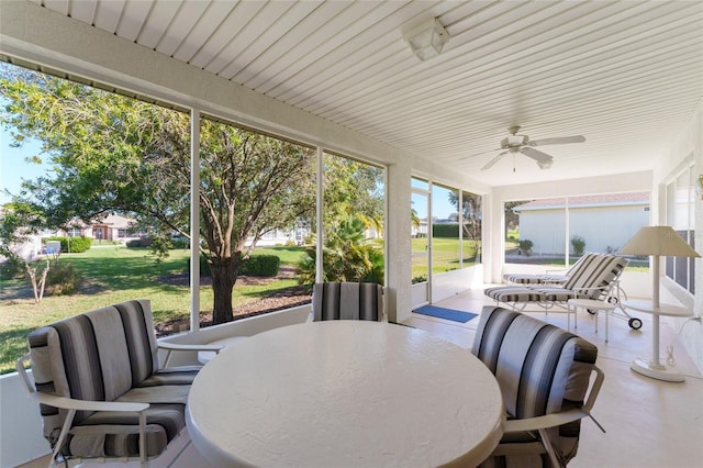 sunroom / solarium with a ceiling fan