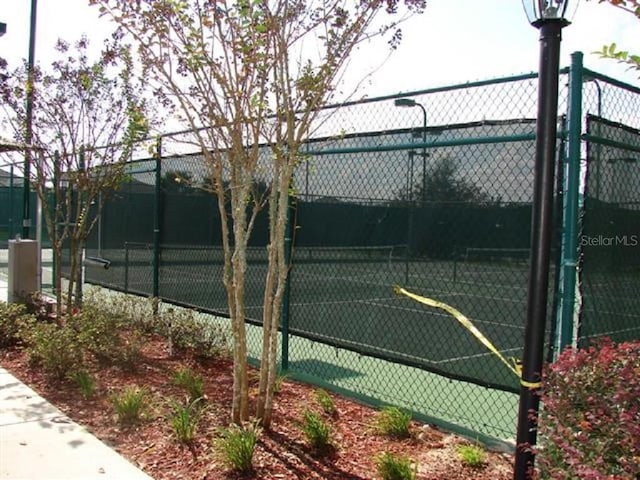 view of tennis court with fence