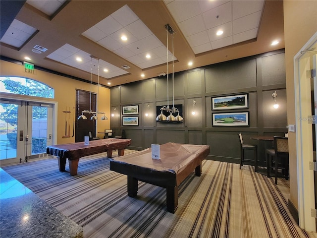 game room with visible vents, a towering ceiling, carpet, a decorative wall, and pool table