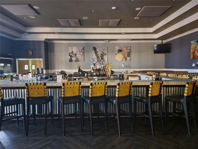 bar featuring a raised ceiling