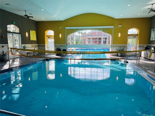 pool with a ceiling fan and french doors