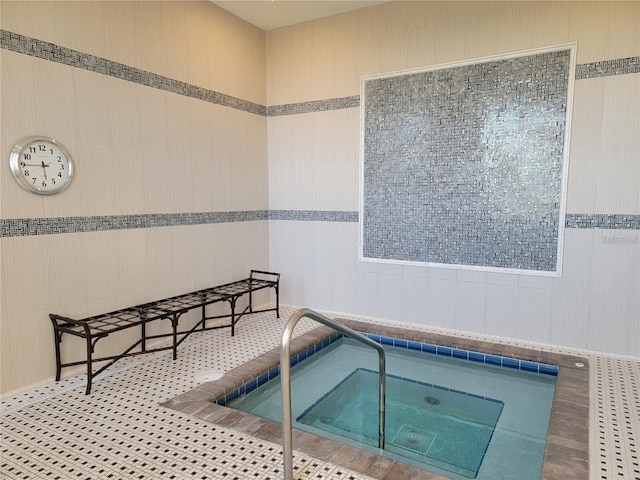 view of pool with an indoor hot tub