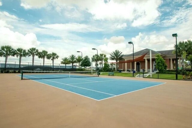 view of tennis court featuring fence