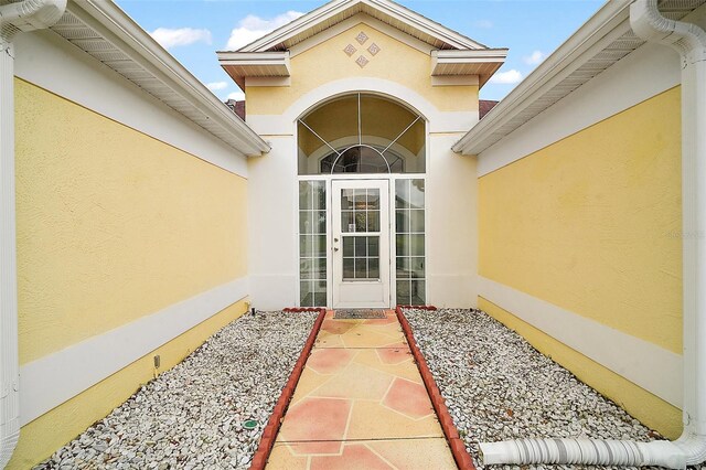 entrance to property featuring stucco siding