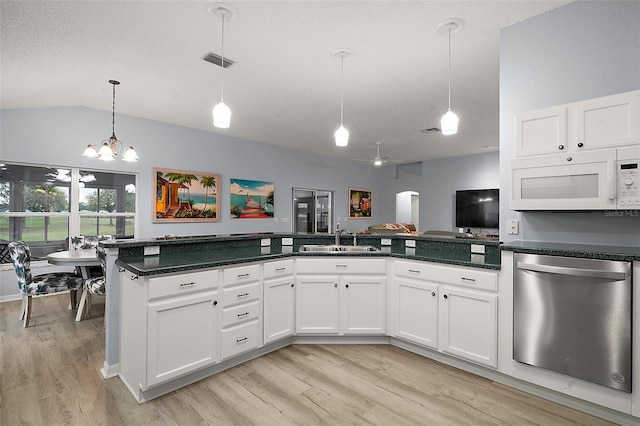 kitchen with white microwave, light wood-type flooring, dishwasher, and a sink
