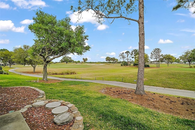 view of property's community with a lawn
