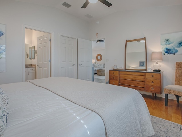 1829 Foxwood Ln, The Villages, FL 32162 - bedroom featuring a ceiling fan, visible vents, ensuite bath, lofted ceiling, and light wood-style flooring