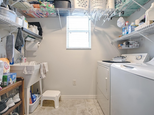 1829 Foxwood Ln, The Villages, FL 32162 - washroom featuring washer and clothes dryer, laundry area, tile patterned floors, and baseboards