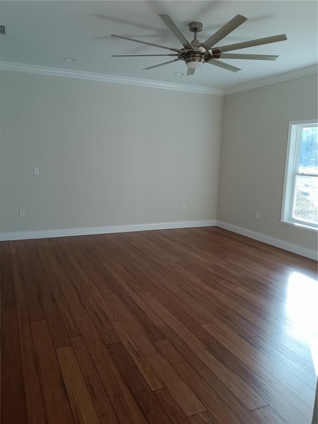 unfurnished room with a ceiling fan, dark wood-type flooring, crown molding, and baseboards