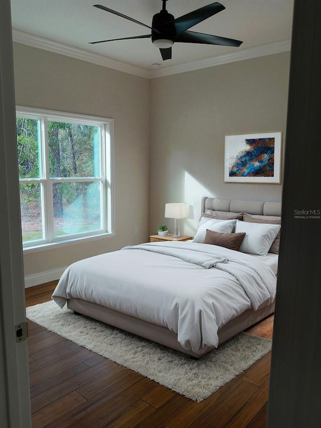 bedroom featuring ceiling fan, crown molding, baseboards, and dark wood-style flooring