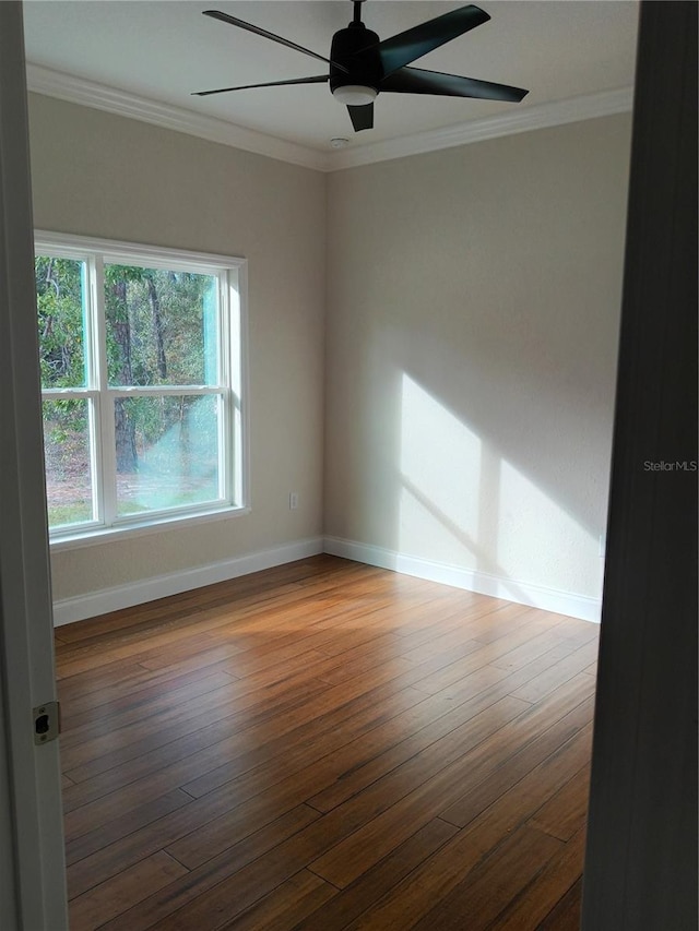 empty room with hardwood / wood-style flooring, ceiling fan, and ornamental molding