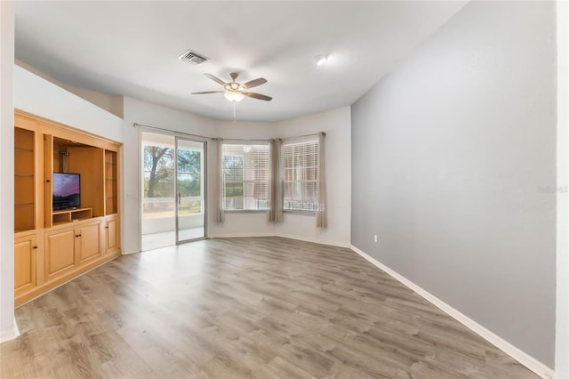 6200 Topsail Rd, Lady Lake, FL 32159 - unfurnished living room with visible vents, baseboards, ceiling fan, and light wood finished floors