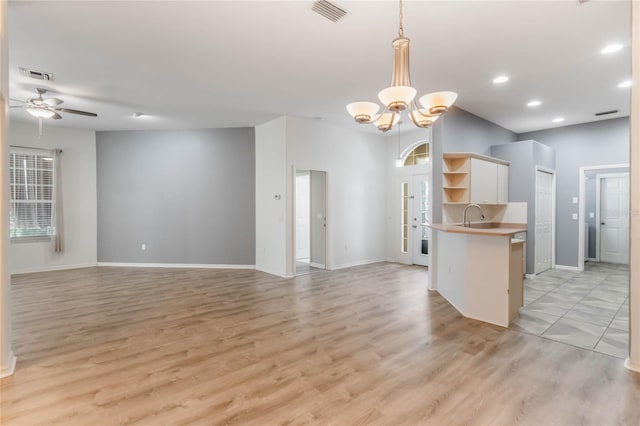 6200 Topsail Rd, Lady Lake, FL 32159 - kitchen featuring visible vents, ceiling fan with notable chandelier, open floor plan, and open shelves