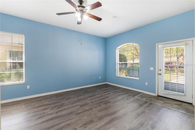 6200 Topsail Rd, Lady Lake, FL 32159 - empty room featuring a wealth of natural light, baseboards, wood finished floors, and ceiling fan