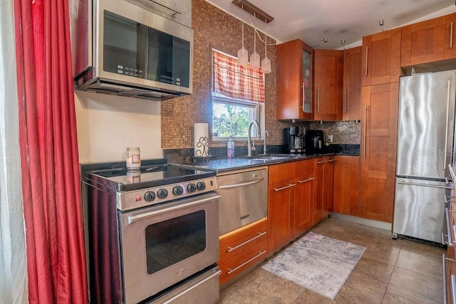 kitchen with glass insert cabinets, backsplash, brown cabinetry, stainless steel appliances, and a sink