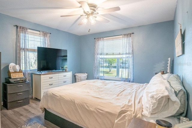 bedroom featuring light wood finished floors and a ceiling fan