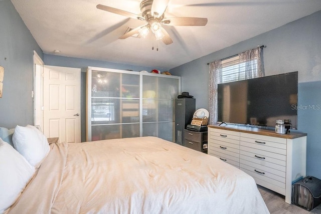 bedroom with ceiling fan and wood finished floors