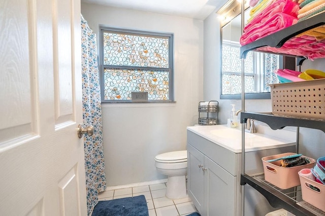 bathroom featuring tile patterned floors, toilet, vanity, and a shower with curtain