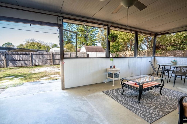 sunroom featuring ceiling fan and outdoor dining area