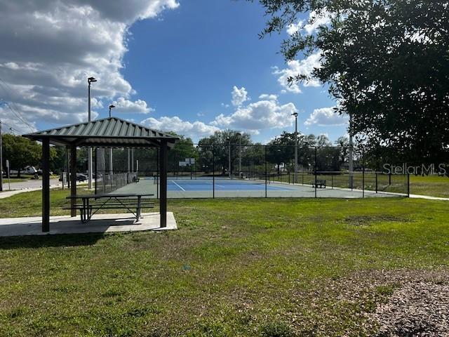 surrounding community with a gazebo, fence, and a lawn