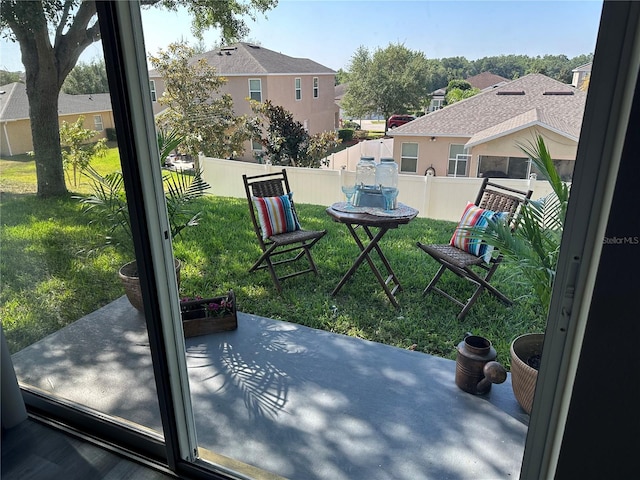 view of patio / terrace with a residential view and fence