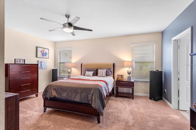 bedroom featuring baseboards, a ceiling fan, and carpet