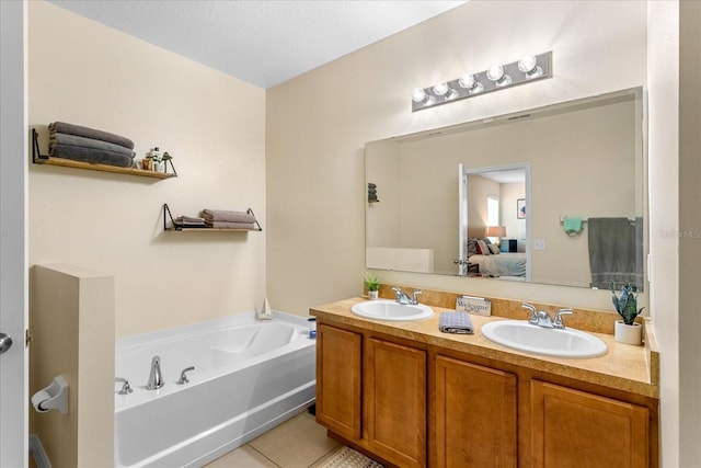 ensuite bathroom featuring a bath, double vanity, ensuite bathroom, and a sink