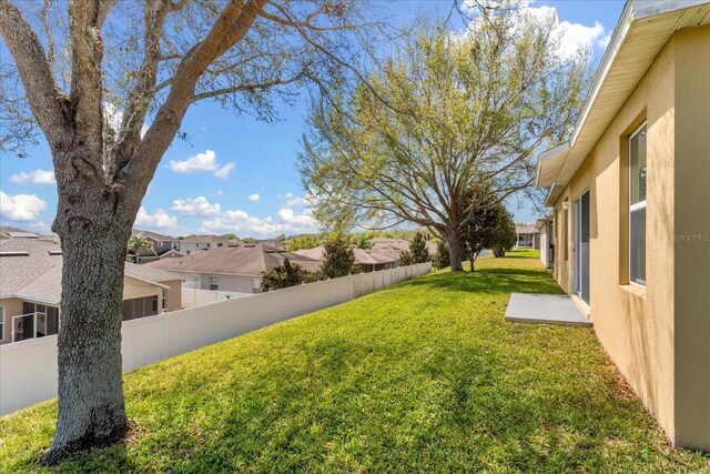 view of yard with a residential view and fence