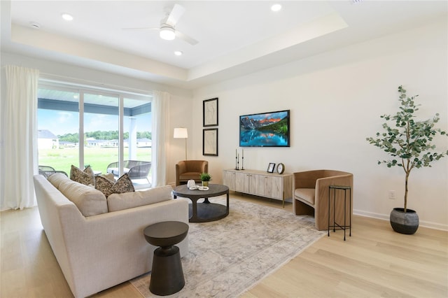 981 Fiesta Key Cir, Lady Lake, FL 32159 - living area with recessed lighting, a ceiling fan, a tray ceiling, and light wood-style floors