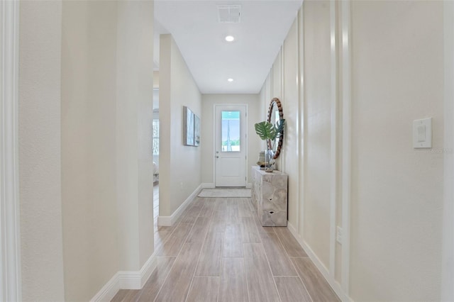 981 Fiesta Key Cir, Lady Lake, FL 32159 - doorway to outside featuring baseboards and light wood-type flooring