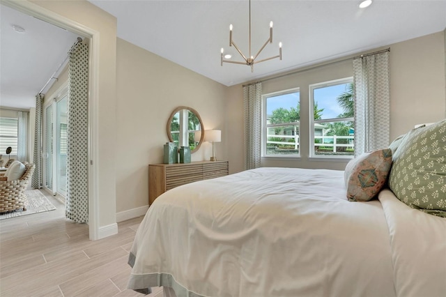 981 Fiesta Key Cir, Lady Lake, FL 32159 - bedroom with multiple windows, a chandelier, baseboards, recessed lighting, and light wood-style floors