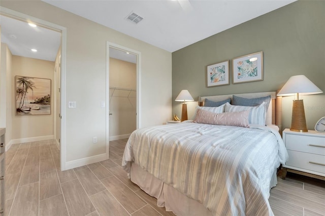 981 Fiesta Key Cir, Lady Lake, FL 32159 - bedroom featuring baseboards, a walk in closet, wood tiled floors, recessed lighting, and a closet