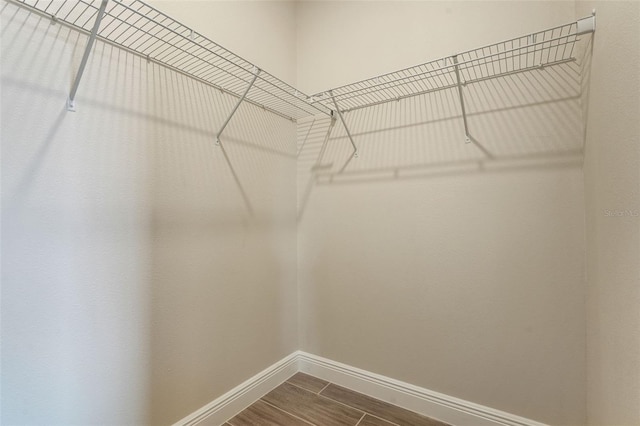 981 Fiesta Key Cir, Lady Lake, FL 32159 - walk in closet featuring dark wood-style flooring