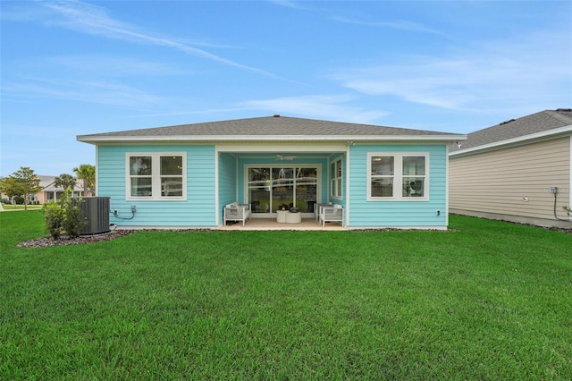 981 Fiesta Key Cir, Lady Lake, FL 32159 - rear view of house with ceiling fan, a patio area, a lawn, and central air condition unit