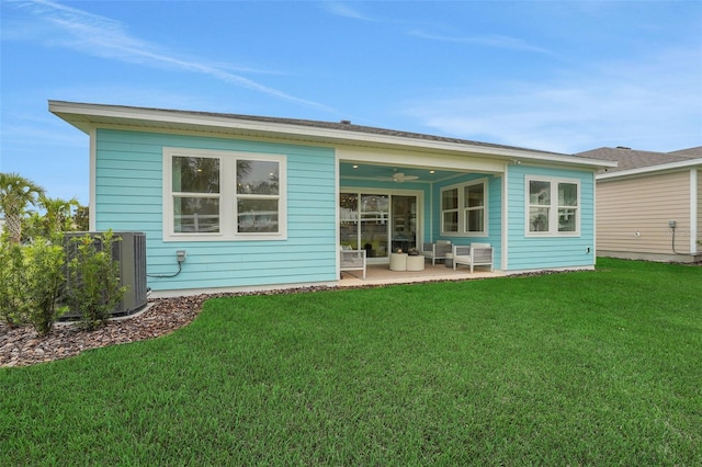981 Fiesta Key Cir, Lady Lake, FL 32159 - rear view of property with outdoor lounge area, cooling unit, a yard, and a patio